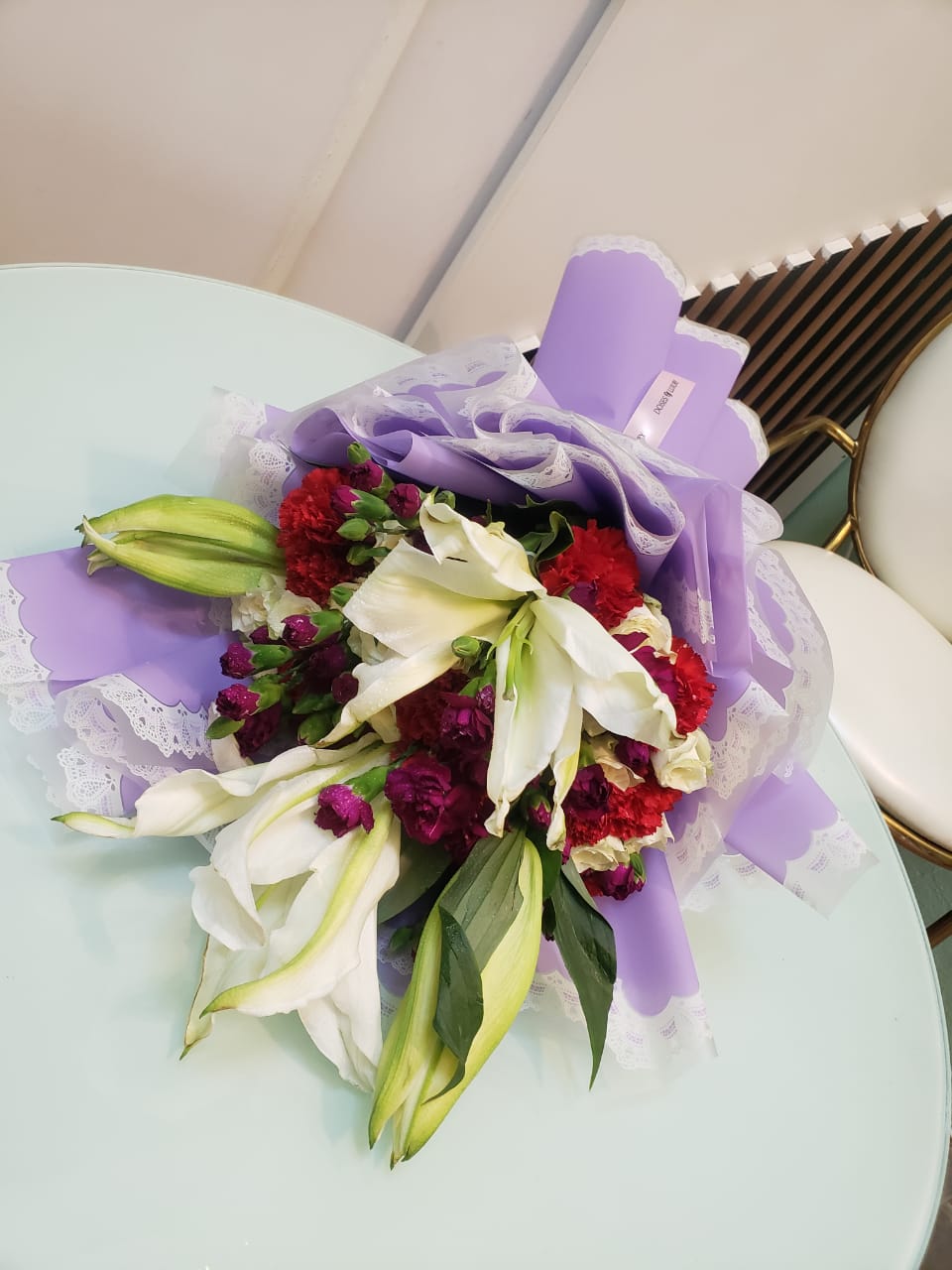 White lily and purple flower bouquet